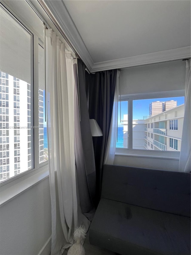 empty room featuring ornamental molding and a water view