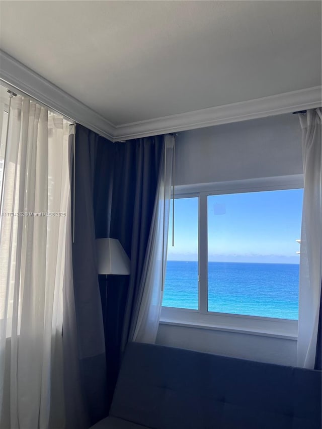 empty room featuring ornamental molding and a water view