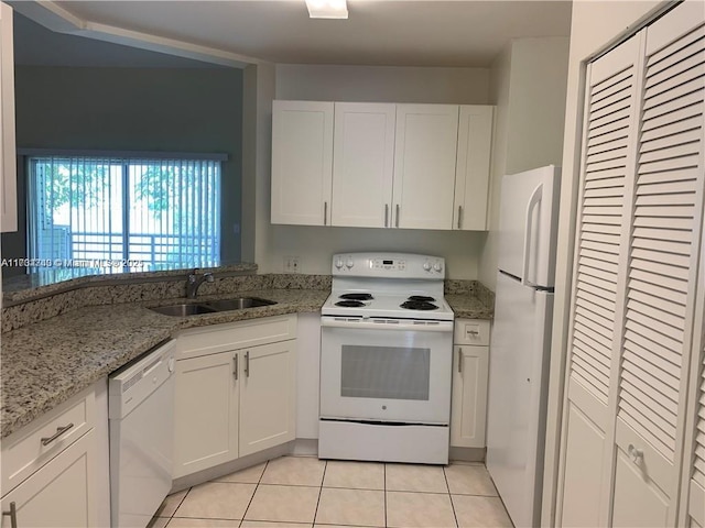 kitchen featuring white cabinetry, sink, white appliances, and light tile patterned flooring