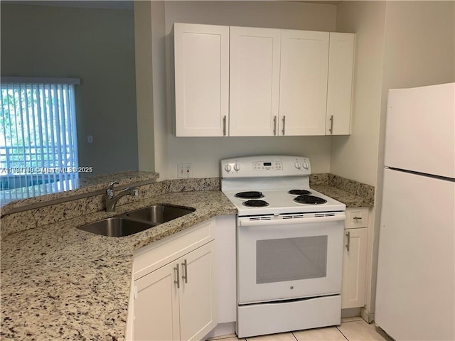 kitchen with white appliances, sink, and white cabinets