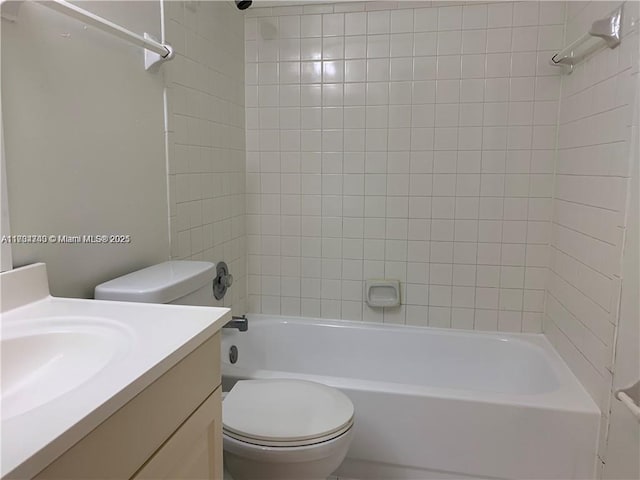 full bathroom with vanity, tiled shower / bath combo, and toilet