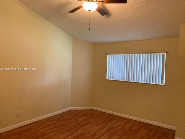 spare room with hardwood / wood-style floors, a textured ceiling, and ceiling fan