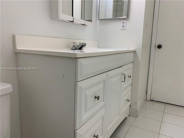 bathroom with vanity, toilet, and tile patterned flooring