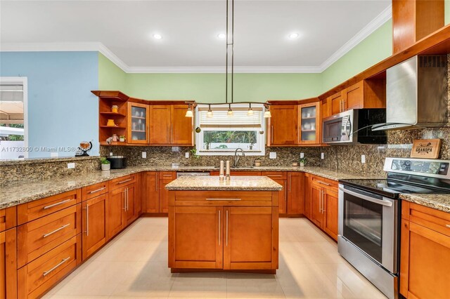 kitchen with a kitchen island, decorative light fixtures, light tile patterned floors, stainless steel appliances, and light stone countertops