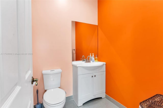 bathroom with tile patterned floors, vanity, and toilet