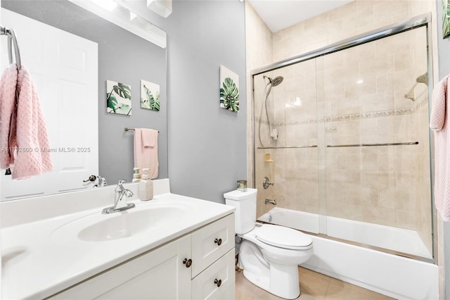 full bathroom with vanity, tile patterned flooring, shower / bath combination with glass door, and toilet