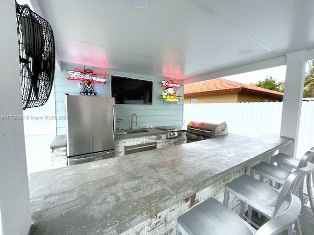 view of patio featuring a grill and a wet bar