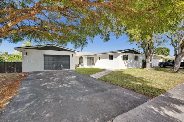 single story home with a garage and a front lawn