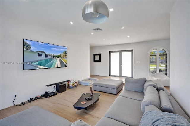 living room featuring french doors and light wood-type flooring