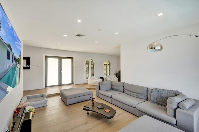 living room featuring light hardwood / wood-style floors and french doors