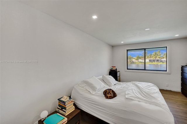 bedroom with hardwood / wood-style flooring