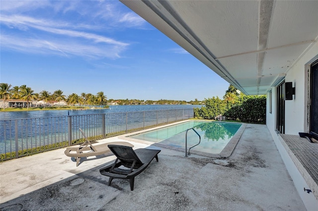 view of pool with a patio and a water view