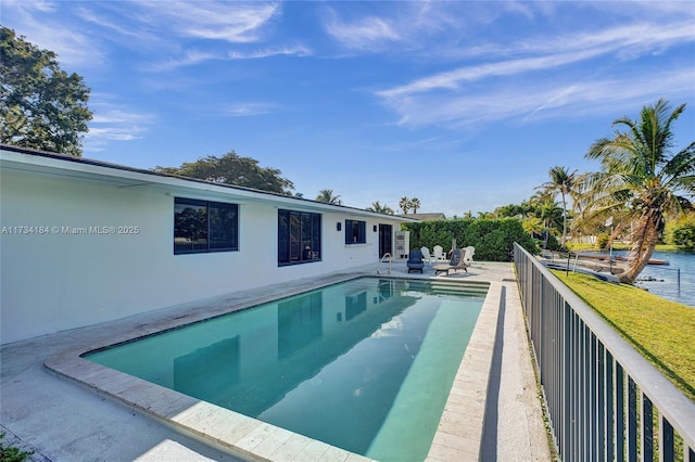 view of pool featuring a patio and a water view