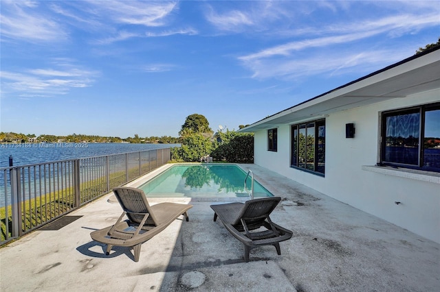 view of pool with a patio and a water view