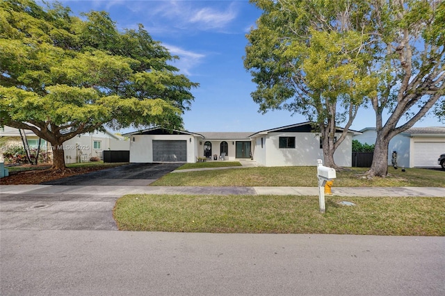 single story home with a garage and a front lawn