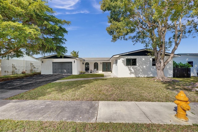 ranch-style house with a garage and a front lawn