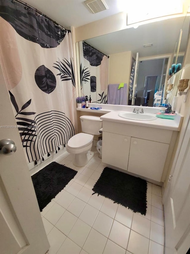 bathroom with vanity, a shower with shower curtain, tile patterned floors, and toilet