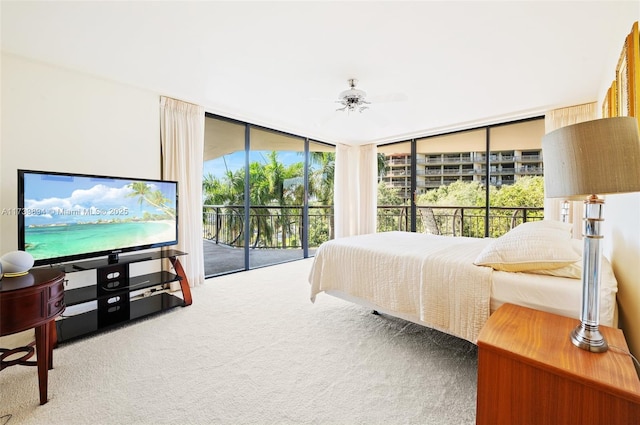 bedroom with carpet floors, access to outside, expansive windows, and ceiling fan