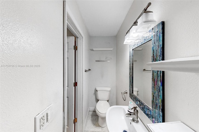 bathroom featuring tile patterned flooring, sink, and toilet