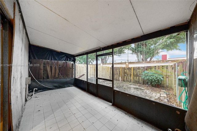 unfurnished sunroom with lofted ceiling