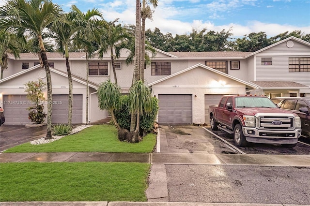 view of front of property featuring a garage and a front yard