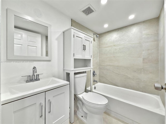 full bathroom with vanity, tiled shower / bath, and toilet