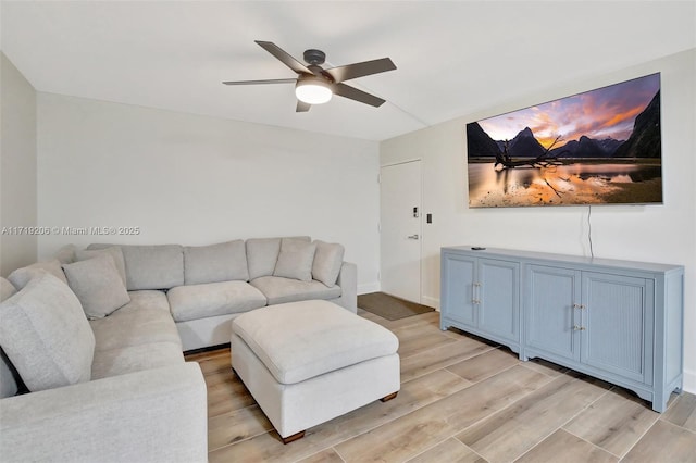 living room with ceiling fan and light hardwood / wood-style floors