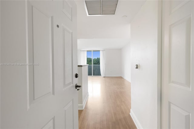 corridor with light hardwood / wood-style floors