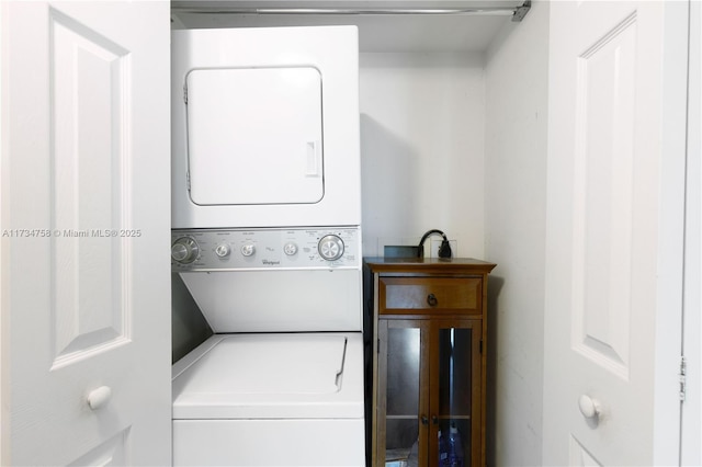 laundry room with stacked washing maching and dryer and laundry area