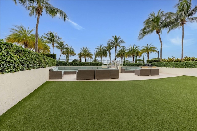 view of yard with fence, a patio area, and outdoor lounge area
