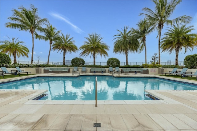 pool featuring an outdoor hangout area, a patio area, and fence