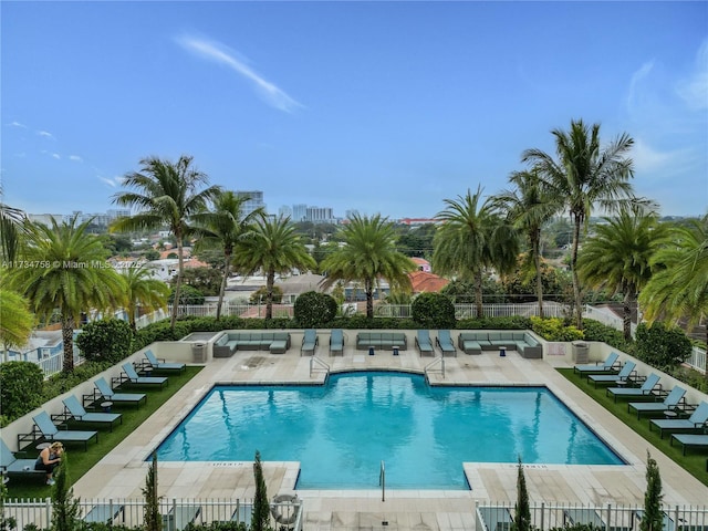 community pool with fence and a patio area