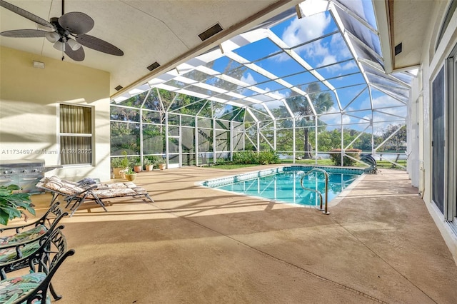 view of pool featuring grilling area, a patio, and glass enclosure