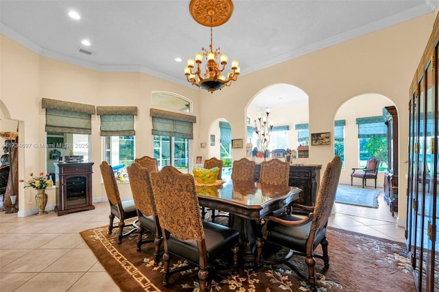 dining area featuring crown molding, beverage cooler, light tile patterned floors, and a notable chandelier