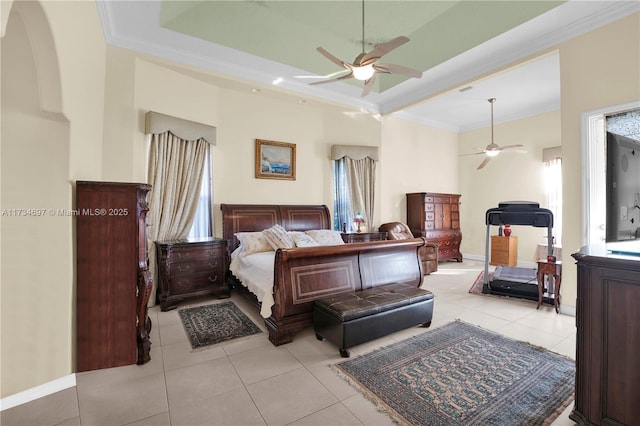 tiled bedroom featuring crown molding, a tray ceiling, multiple windows, and ceiling fan