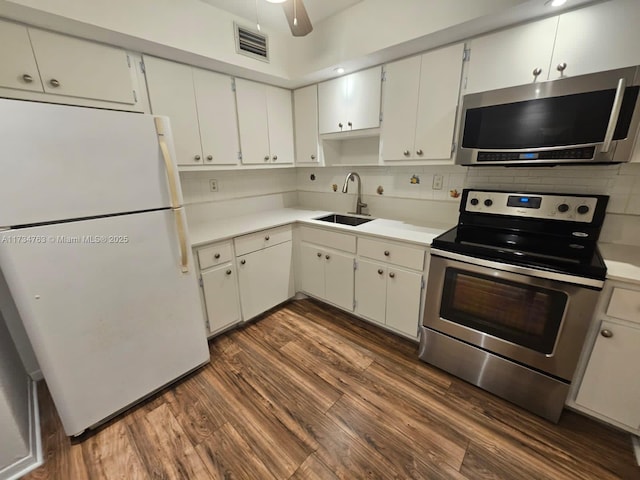 kitchen with white cabinetry, sink, dark hardwood / wood-style flooring, and appliances with stainless steel finishes