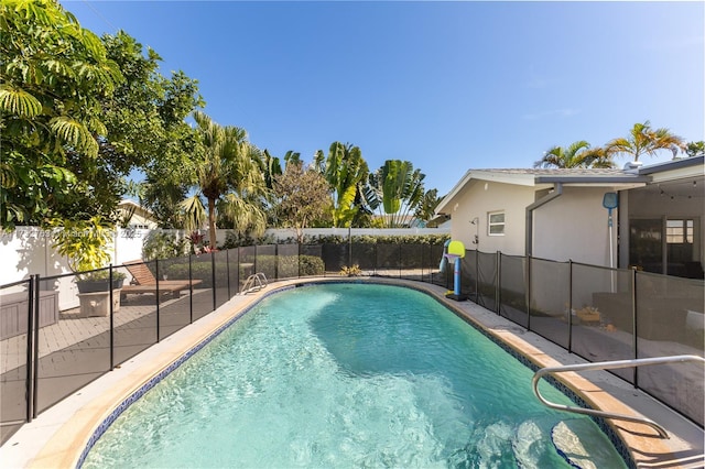 view of swimming pool featuring a patio area, a fenced in pool, and a fenced backyard