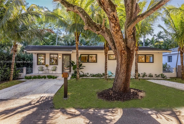 view of front of house with a front yard and covered porch