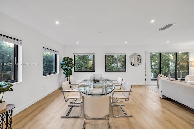 dining space with light hardwood / wood-style flooring