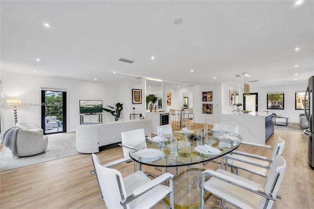 dining area with a healthy amount of sunlight and light hardwood / wood-style flooring