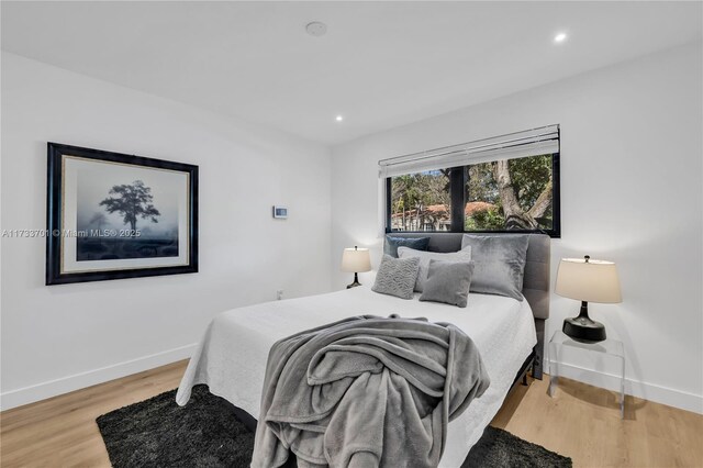 bedroom with hardwood / wood-style flooring