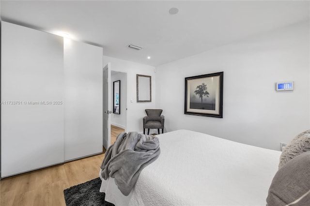 bedroom with wood-type flooring