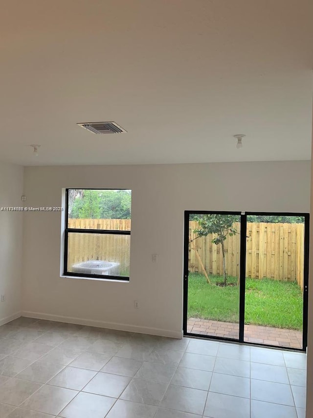 unfurnished room featuring light tile patterned floors