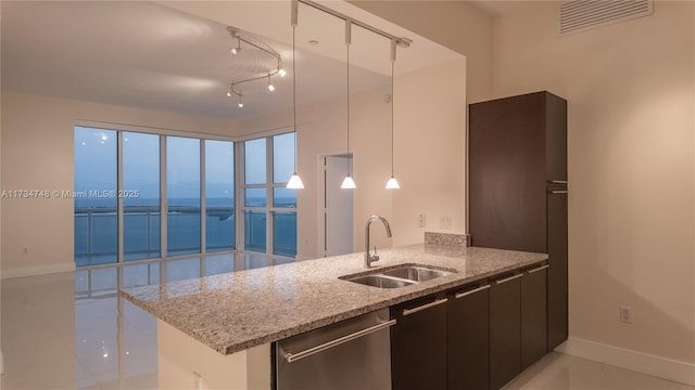 kitchen with decorative light fixtures, dishwasher, sink, a water view, and light stone countertops