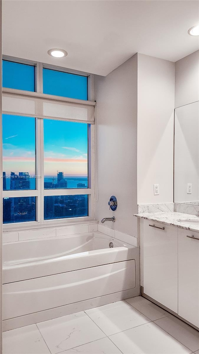 bathroom featuring vanity and a tub