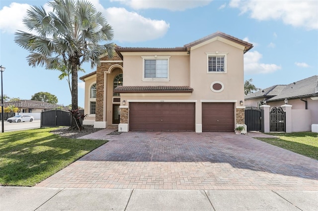 mediterranean / spanish-style house featuring a garage and a front yard