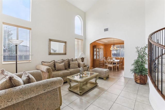 living room with a chandelier and light tile patterned flooring