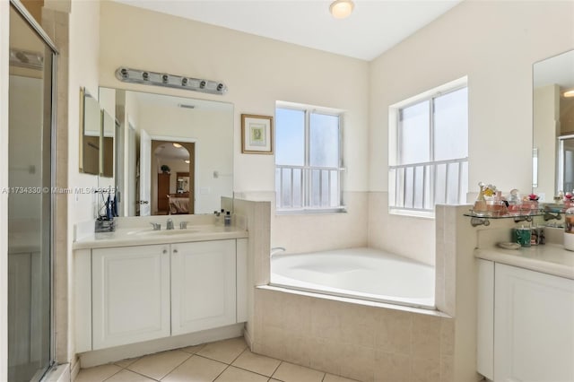 bathroom with tile patterned flooring, vanity, and independent shower and bath