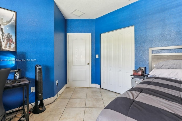 tiled bedroom featuring a closet