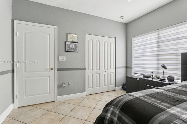 tiled bedroom featuring a closet